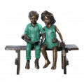 two children sitting on bench reading bronze statue sculpture